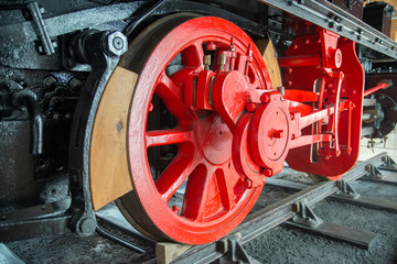 Fototapeta na wymiar Retro steam locomotive red metal wheels