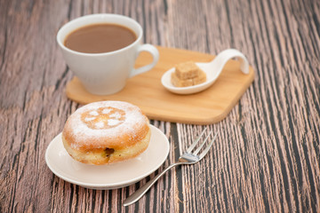 Dessert, Donuts, chocolate and strawberry circles, sugar and cream on Donuts and hot coffee cups, preparation for a break or party on the wooden table background.