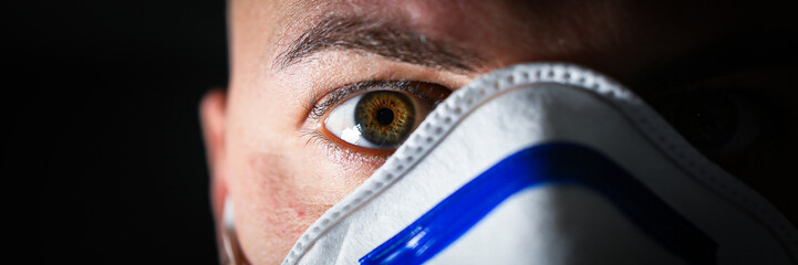 boy with green eyes and with a mask to avoid contagion from the Coronavirus COVID-19