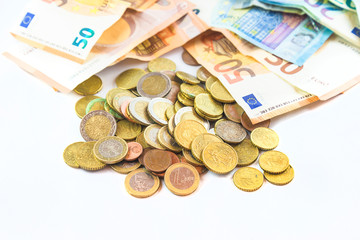 Economic crisis concept. Heap of euro banknotes and coins on white background