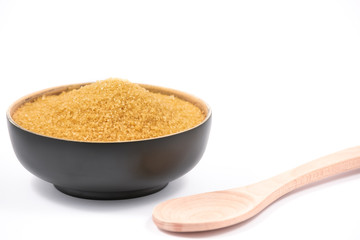 Brown sugar in a wooden bowl or wooden spoon Sugar for health Use for cooking or desserts on white and sugar backgrounds.