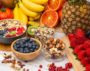 Group Fruits Breakfast mixed vegetables with salad bowl, nuts bowl, strawberry, banana, and pineapple, orange juice,  vitamin c in food  nature for health and diet in the top view on the wood table.