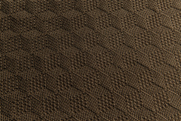 Brown knitted fabric texture. Product from wool. Handwork