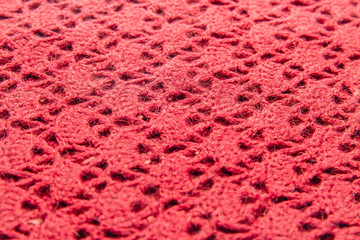 Pink wool knitted fabric with texture. Handwork.