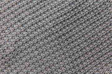 Grey knitted fabric texture. Product from wool. Handwork