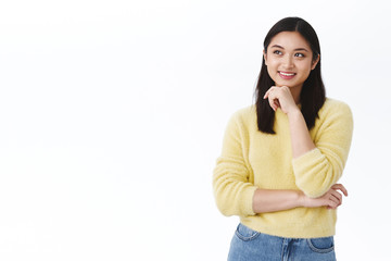Dreamy cute young female student and part-time worker imaging her future after graduation, have interesting idea, standing thoughtful white background, smile and look up pondering