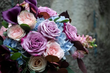 Beautiful bouquet of purple callas, light roses and blue hydrangea. Flowers rose bouquet.