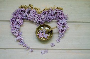 Heart of lilac flowers on a wooden gray table. flowers lilac © toniton