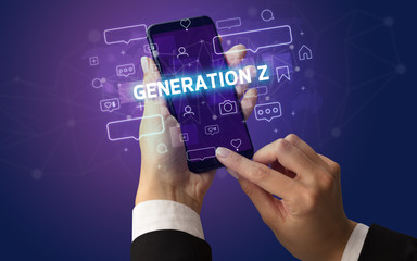 Female hand typing on smartphone with GENERATION Z inscription, social media concept