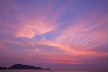 Stunning purple sunset on a tropical beach.