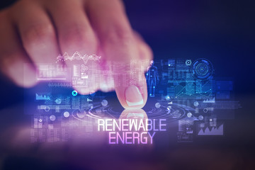 Finger touching tablet with web technology icons and RENEWABLE ENERGY inscription