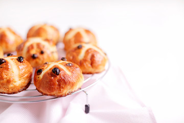 Buns marked with a cross and containing dried fruit, traditionally eaten during Lent.
