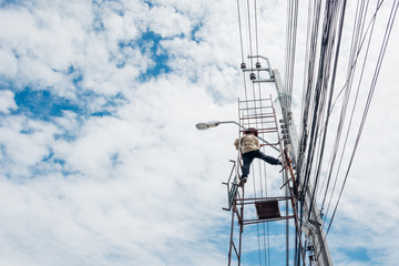Electricians risk working install electric line