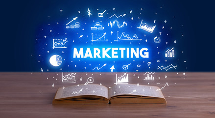 MARKETING inscription coming out from an open book, business concept