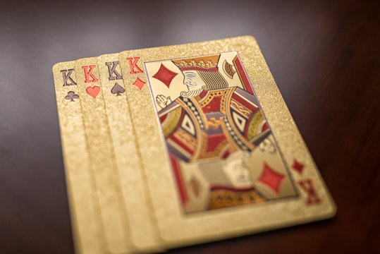 four king playing cards on wooden background shallow depth of field, four playing cards of the same suit diamonds sign in sharpness, playing cards one on one from above the king of diamonds