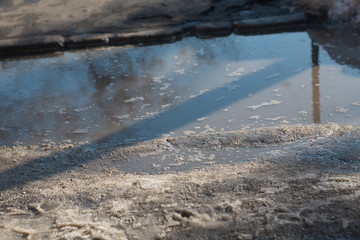 Spring puddles, snowdrifts, snow, mud and melted dirty water