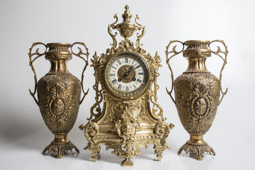 bronze amphorae and clock on a white background, antique vases and clock studio photo, antique...