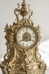 dial of vintage bronze watch , antique clock photo close up, old bronze clock in gilding, front of...