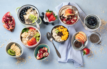 Bowls of oatmeal with berries and fruits  for healthy breakfast. Food with vitamins, minerals and antioxidants. Top view