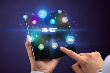 Businessman holding a foldable smartphone with CONNECT inscription, social media concept