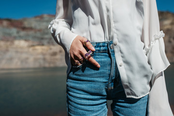Close up photo of unrecognisable model hand wearing few purple handmade floral rings- beauty and jewellery concept. 