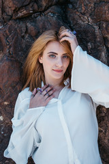 Romantic portrait of beautiful model wearing handmade jewellery,  rings, necklace, bracelet. Outdoors portrait on sunny day.  