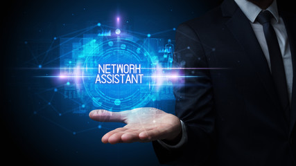 Man hand holding NETWORK ASSISTANT inscription, technology concept