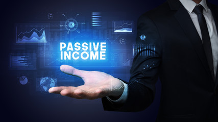 Hand of Businessman holding PASSIVE INCOME inscription, business success concept
