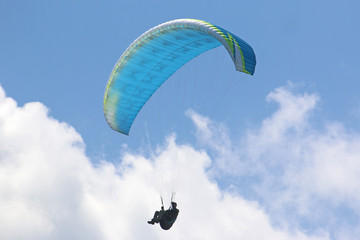 Paraglider flying wing in a blue sky	
