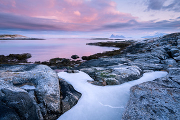 An early morning seascape photographed at sunrise in the small fishing village of Sommaroy, Norway.