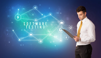 Businessman in front of cloud service icons with SOFTWARE TESTING inscription, modern technology concept