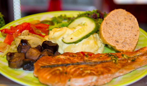 grilled somon fish and vegetables in the dish
