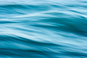 An abstract close up photograph showing the motion and power of the waves in the ocean.