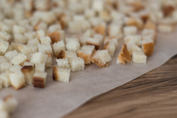 homemade breadcrumbs from white bread to dry on the paper