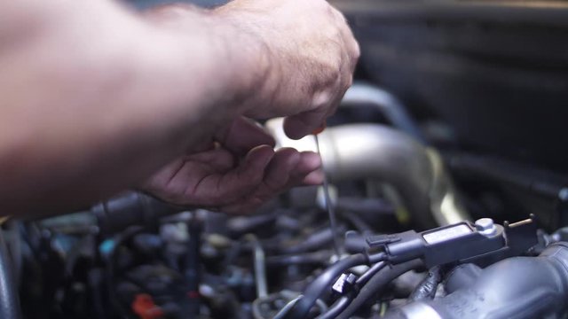 mechanic working on car engine