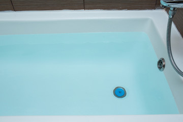 Blue water in the bath. Bathroom. Top view.