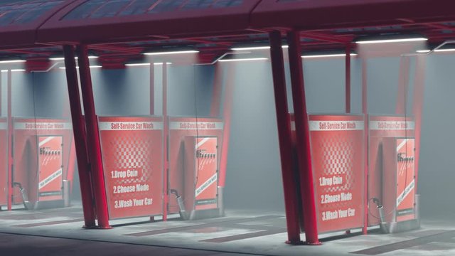 Row of red self-service car wash bays with coin-operated machines