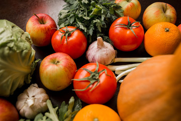 Fototapeta na wymiar onions, garlic, tomato, greens, parsley, arugula, cabbage, apples, beetroot, carrots, pumpkin, lie on a wooden table