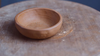 Handmade Clay Bowl Of Yixing Clay On Hand-Painted In The Form Of Bamboo On A Wooden Circle. Clay Pottery Ceramics. High Quality Photo
