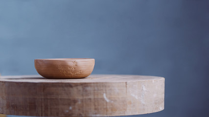 Handmade Clay Bowl Of Yixing Clay On Hand-Painted In The Form Of Bamboo On A Wooden Circle. Clay Pottery Ceramics. High Quality Photo