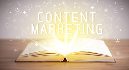Open book with CONTENT MARKETING inscription, social media concept