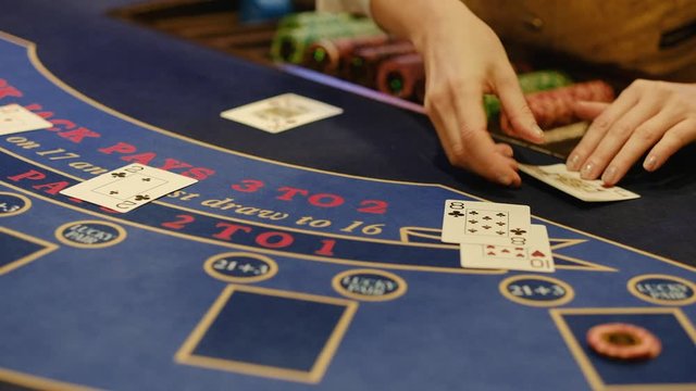 Closeup of Playing poker. The croupier stacks playing tokens, Casino gamble. 