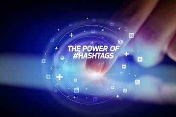 Finger touching tablet with social media icons and THE POWE OF #HASHTAGS