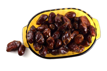 Date fruits on plate isolated on white