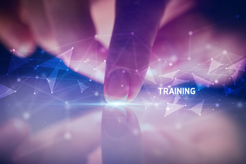 Finger touching tablet with TRAINING inscription, business concept