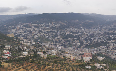 Fototapeta na wymiar Landscape view of the city of Ajlun in the North of Jordan in the Spring with lush countryside and olive groves