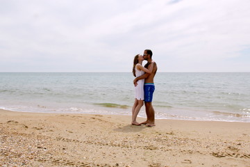 Young couple frolicking on the beach