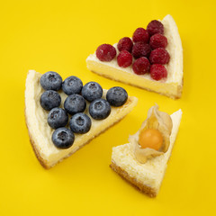 Slice of blueberry cheesecake on a yellow background. Minimalistic composition.