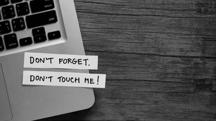 Don't Touch ME! message concept written post it on laptop keyboard.