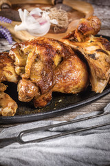 Quarters of fried chicken in a cast iron skillet.